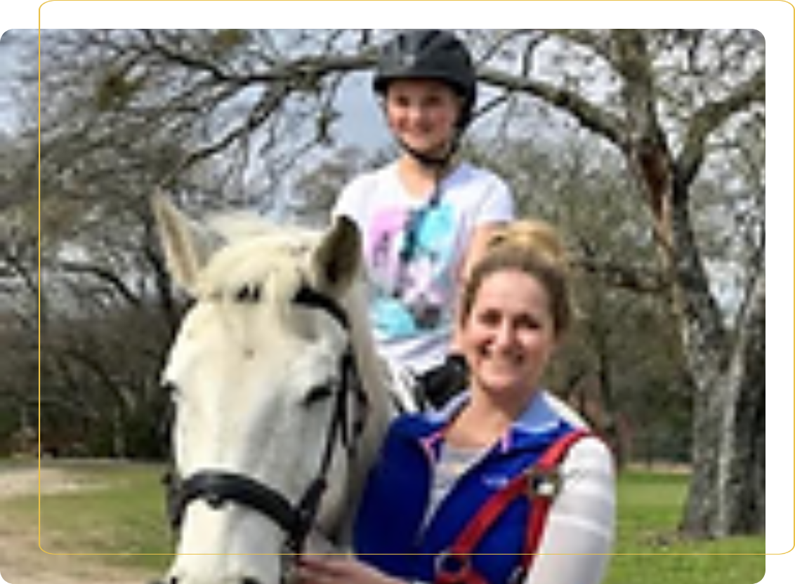 A woman and child are standing next to a horse.