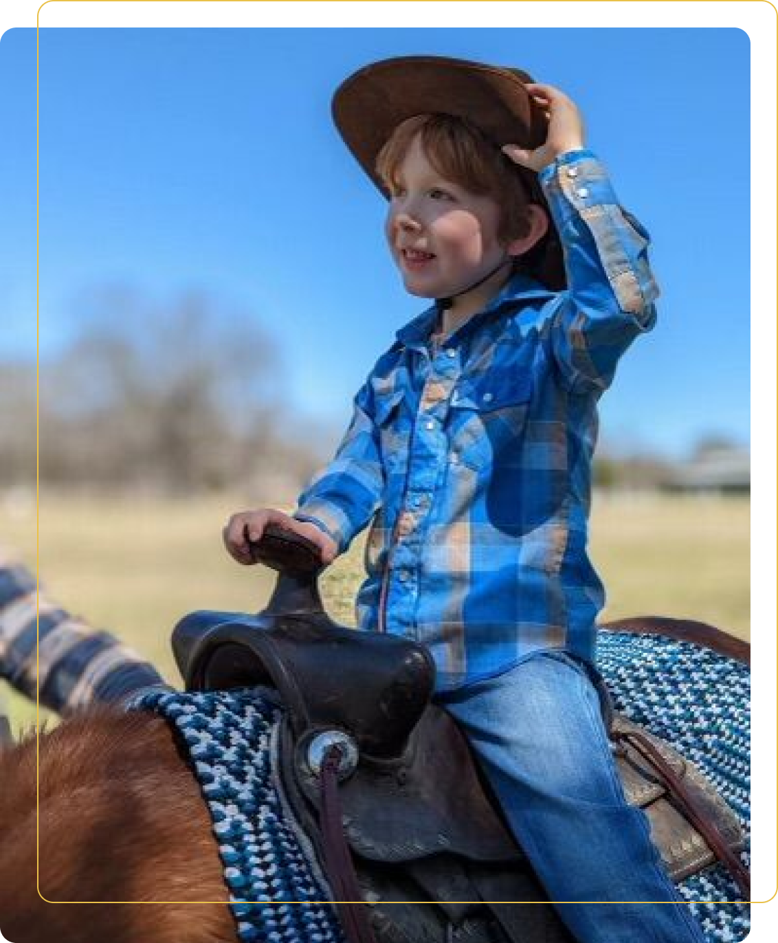 A young boy riding on the back of a horse.